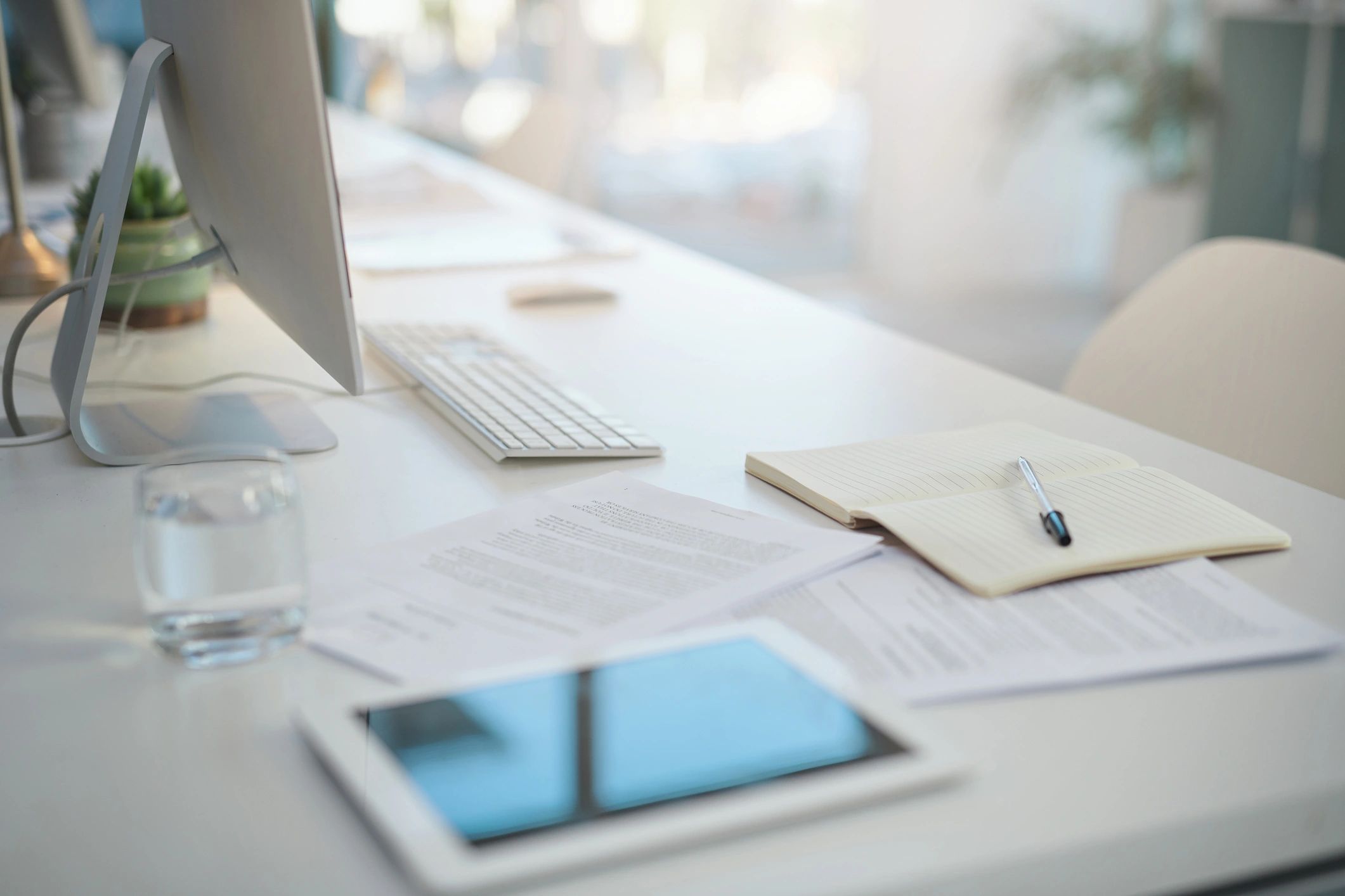 Modern office desk with documents and laptop